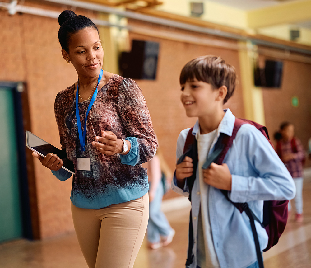 Teacher walking and listening to a student